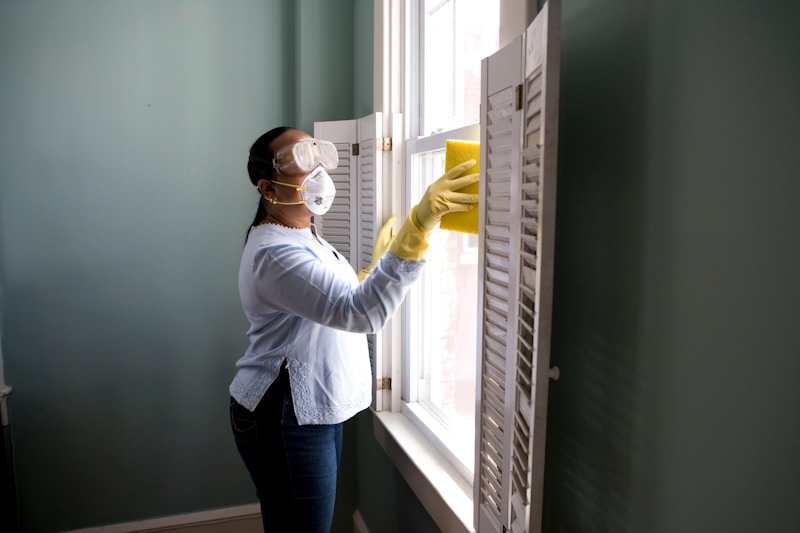 Housekeeper dusting kitchen table